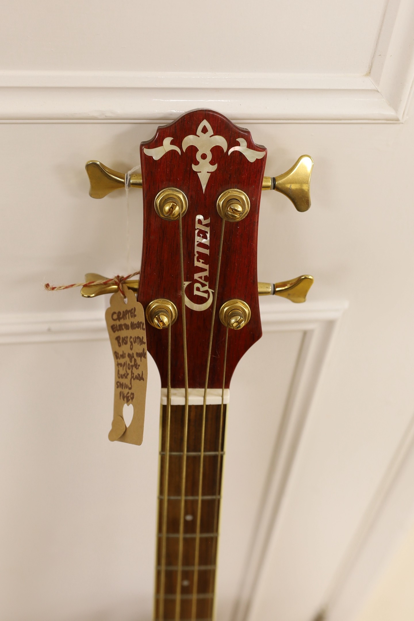 A Crafter electro-acoustic bass guitar. Model No. BA-600EQ/AMS-P Serial No. 00202718, 113cms high.
